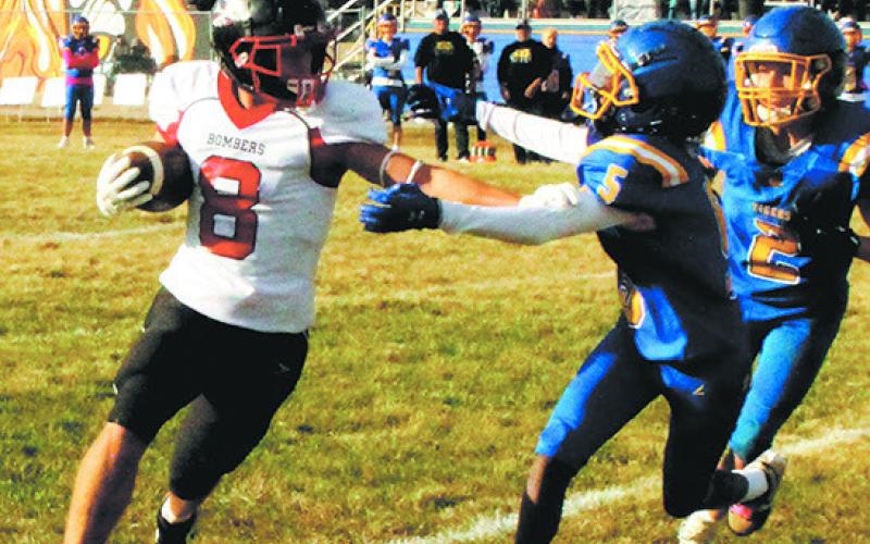 Drayton's Carter Johnson stiff-arms Trenten defender Tae Slater to advance the run. Photo by Jamie Rarick.