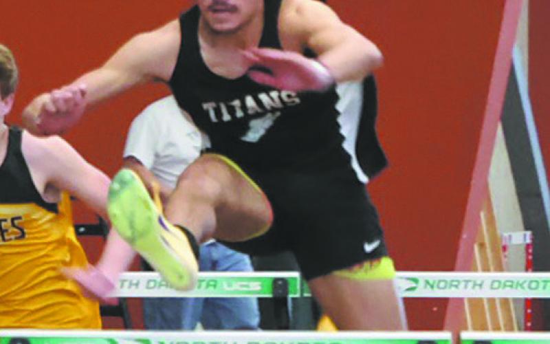 DVE junior Mason Pollestad gets an early lead over competitors in the Men's 60M Hurdles, winning the event with a personal best of 8.60. Photo by Jamie Rarick