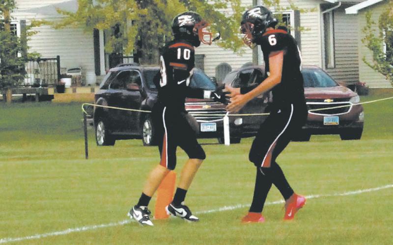 Teammates Shawn Patterson and Jonah Rarick celebrate in the endzone following a Bomber touchdown. Photo by Jamie Rarick