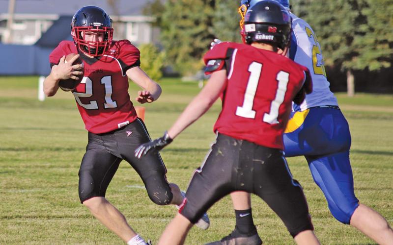 Cayden Quibell advances the ball down the gridiron while Jamie Larocque blocks a member of the Trenton Tigers team. VNV Photo by Lesa Van Camp