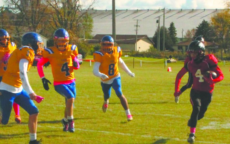 Being chased by Trenton defenders, senior Trypp Castillo sprints down the sideline. Photo by Jamie Rarick.