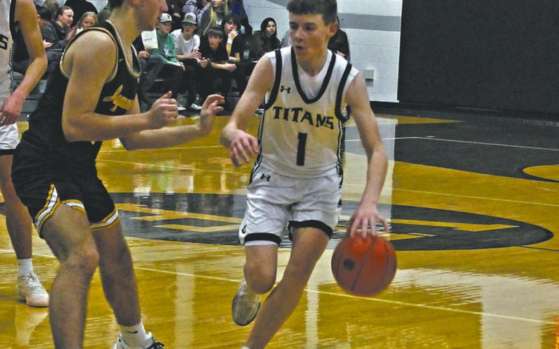 DVE Senior Drew Passa moves the ball down the court. Photo by Jamie Rarick