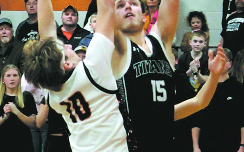 DVE's Isaac Feltman goes for the shot over Cavalier's Breckon Thorpe. Photo by Jamie Rarick