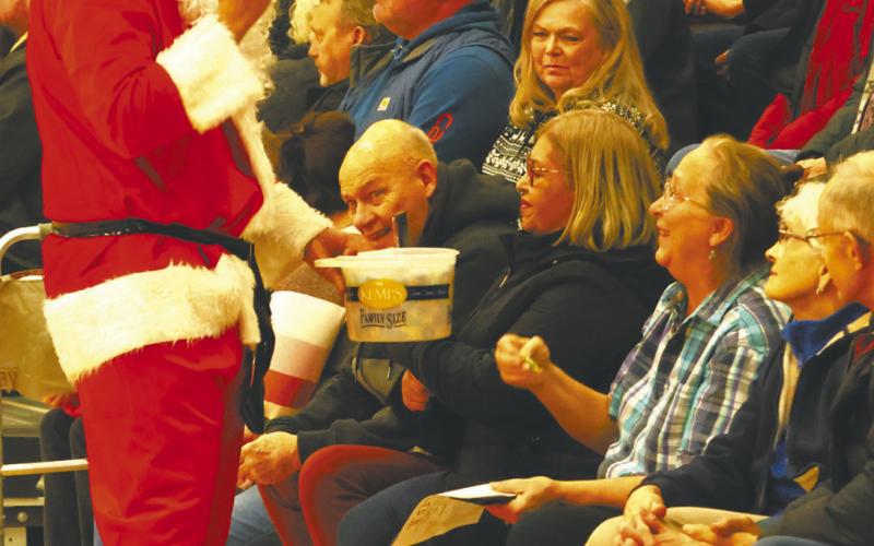 Santa Claus passed out treats to the audience during the Christmas play. Photo by Lyle V an Camp