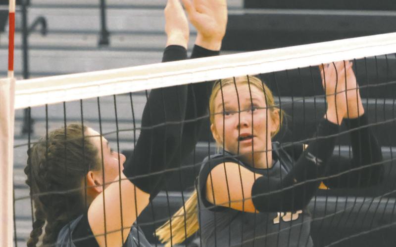 Elizabeth Fedje and Easton Larson go up for a block attempt in Drayton last week. Photo by Lyle Van Camp