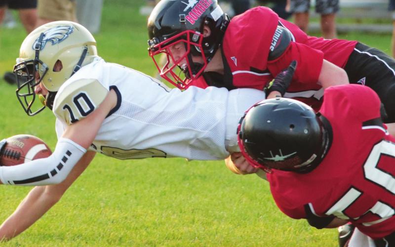 Jamie Larocque and Gavin Ryan bring down a North Border ball carrier last Friday. VNV photo by Lyle Van Camp
