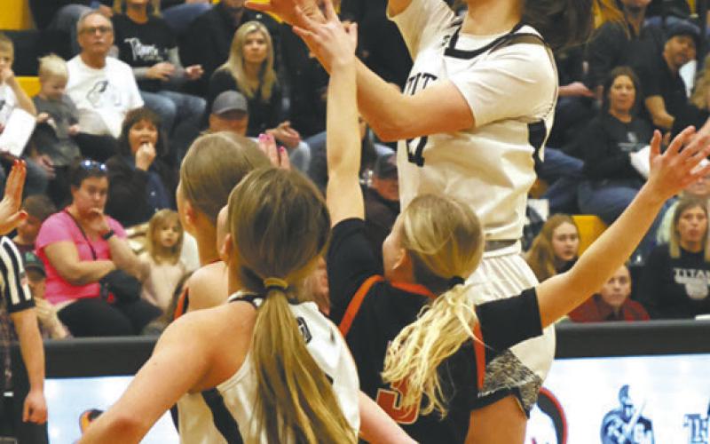 DVE senior Elizabeth Fedje gets the shot off over Cavalier defender Nevaeh Schroeder. Photo by Jamie Rarick