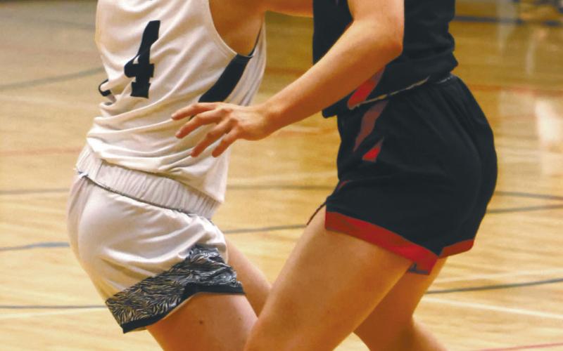 Greta Burrell looks for an open teammate in action against Midway Minto in Drayton last week. Photo by Lyle Van Camp