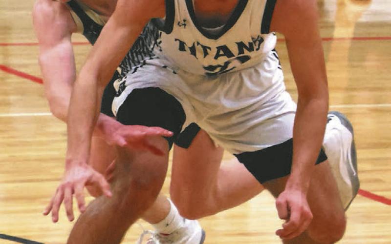 Trenten Keena fights off an attempted steal by a North Border defender.