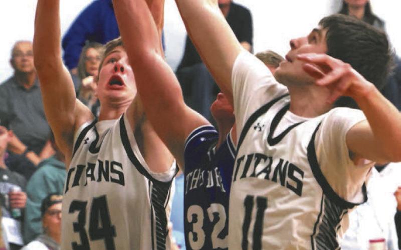 Evan Feltman and Jack Langerud fight a Hatton-Northwood player for control of the ball.