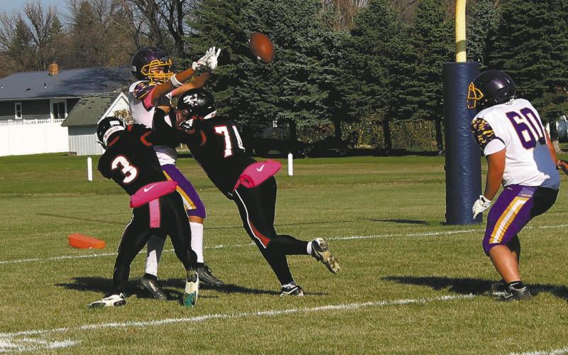 Trenten Keena and Praise Chairez take down the Eagles quarterback, resulting in an incomplete pass. Photo by Jamie Rarick.