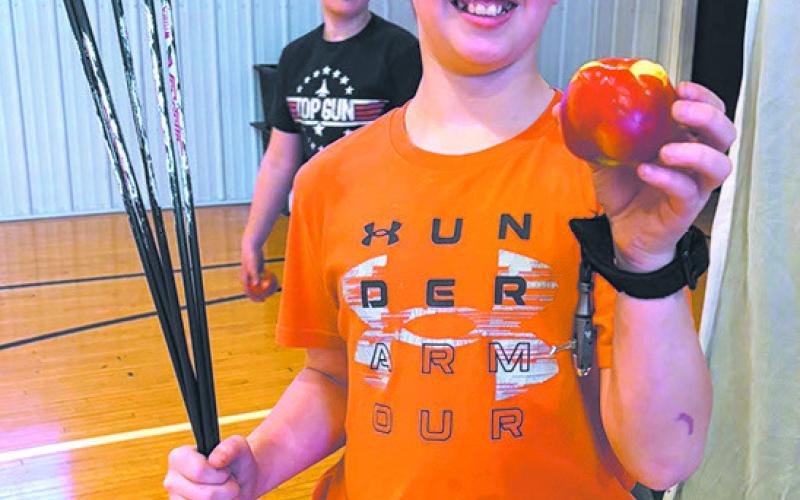 Levi N. shows off the apple he knicked with the arrow. Submitted photo. Submitted photo.