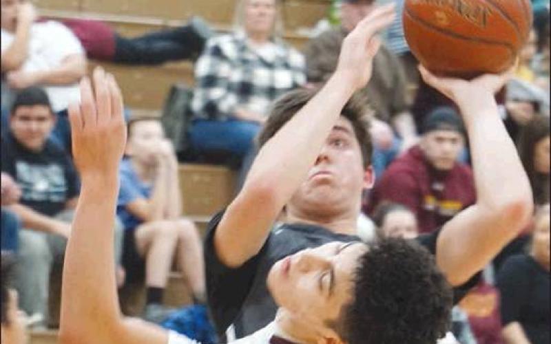 Tyson Backer forces a shot past Grafton’s Justin Garza. VNV Photo by Lyle Van Camp
