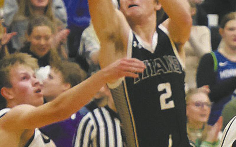 DVE junior Teddy Otto goes for the shot over an Aggie defender. Photo by Jamie Rarick