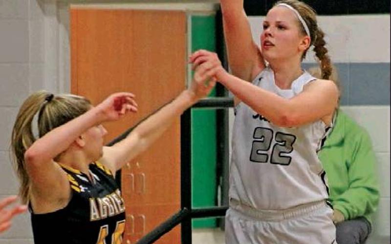 Kasey Stegman takes a shot while Peyton Schroeder defends against her. Photo submitted by Kerri Stegman, Drayton Public School