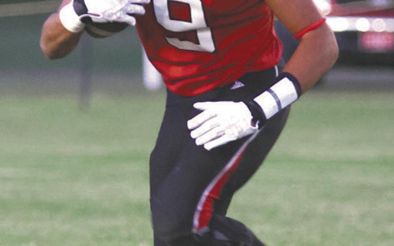 Mason Pollestad looks up the field for an opening. Photo by Lyle Van Camp