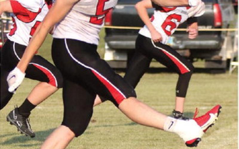 Grant Vold kicks off after a Bombers score late in the game. Photo by Lyle Van Camp.