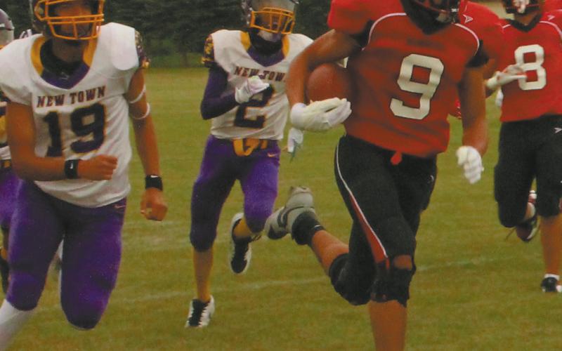 Mason Pollestad outruns the Eagle defense for another Bomber touchdown gainst New Town. Photo by Jamie Rarick.