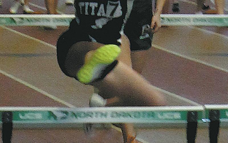DVE freshman Jocelyn Vold leaps over the hurdle in the Girls 60 M Hurdles. Vold earned a place in the finals, placing 7th overall and setting a new personal record. Photo by Jamie Rarick