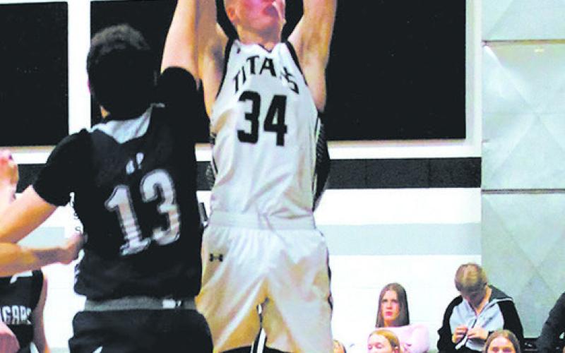 DVE junior Jack Langerud secures the rebound over North Prairie junior Julius Elick. Photo by Jamie Rarick.