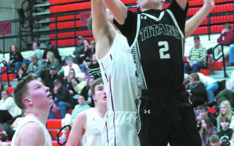 Quinn Passa lays in a left hand layup against the Cards. Photo by Larry Stokke