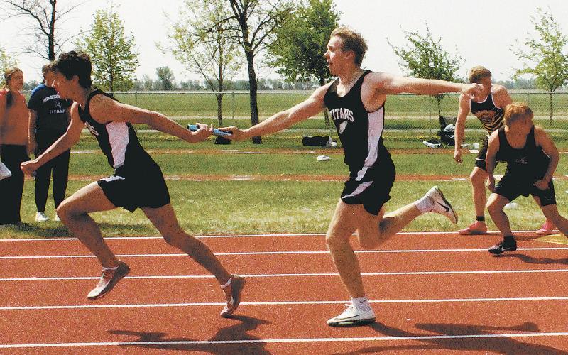 Carter Oberg passes the baton to Brady Reilly in the boys 4x200 relay. Along with teammates Carter Johnson and Jack Langerud, they won the regional championship and set a new North East Region meet record with a time of 1:33.92. Photo by Jamie Rarick