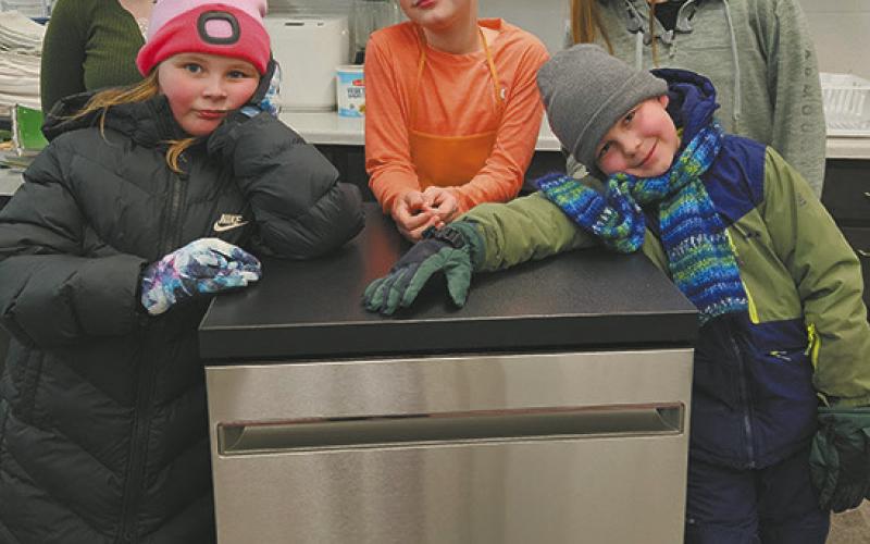 Students from the After-School Program Cooking Class pictured with the new dishwasher purchased with grant funds. Front (L-R) Teagan Taylor and Mikhail Fleishman; Back (L-R) Brooklynne Petersen, Keagan Delohery, and Natasha Shepard. Photo by Shelly Quimby