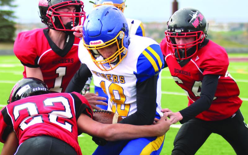 Lucas DeSouza, Jonah Rarick, and Landon Mapel team up to stop Trenton’s Maddix Longie on one of the last plays of the game.