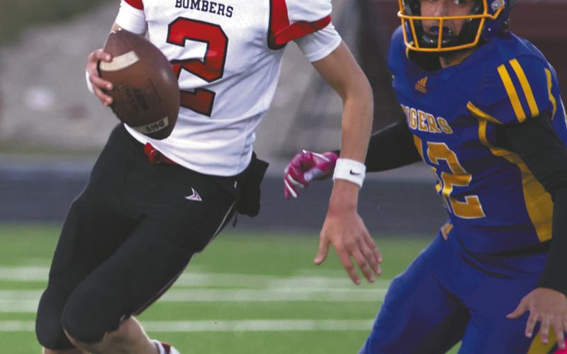 Quinn Passa looks for an open receiver. Photo by Lyle Van Camp
