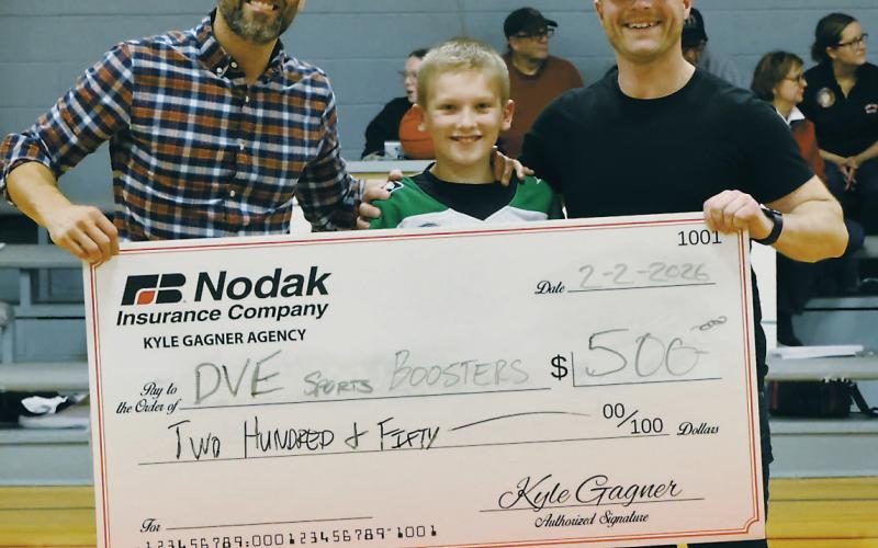 At half-time, a check was presented by Kyle Gagner of Nodak Insurance, pictured with Kyle Johnson and Ryan Beattie. Photo by Jamie Rarick