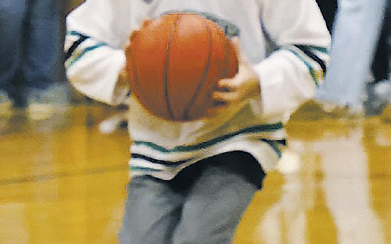Kyle Johnson takes the half-court challenge from Nodak Insurance during half-time at Thursday's game in Crystal. Photo by Jamie Rarick