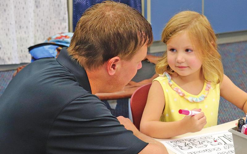 Jason Melland and daughter Berklee share a sweet moment as they say goodbye on the first day of school as she starts Kindergarten. VNV Photo by Lesa Van Camp
