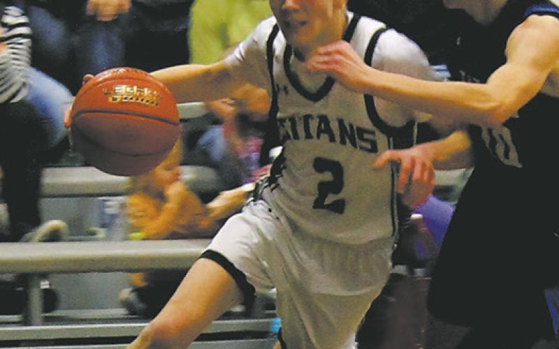 DVE senior Quinn Passa drives past a Griggs-Midkota's defender in Edinburg Feb. 8. Photo by Jamie Rarick