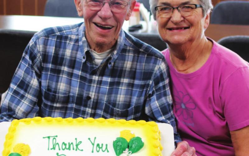 Danny and Virginia Pokrzywinski pose with the the cake seved at Danny’s retirement celebration. VNV photo by Lyle Van Camp