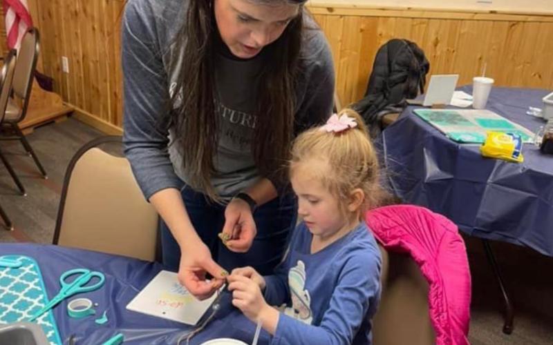 Christine Sibilleau, Independent Chalk Couture Designer, Roseau, Minn., helps with a project during the Riverfest event in Drayton over the weekend. Photos by Jessica M. Woinarowicz.