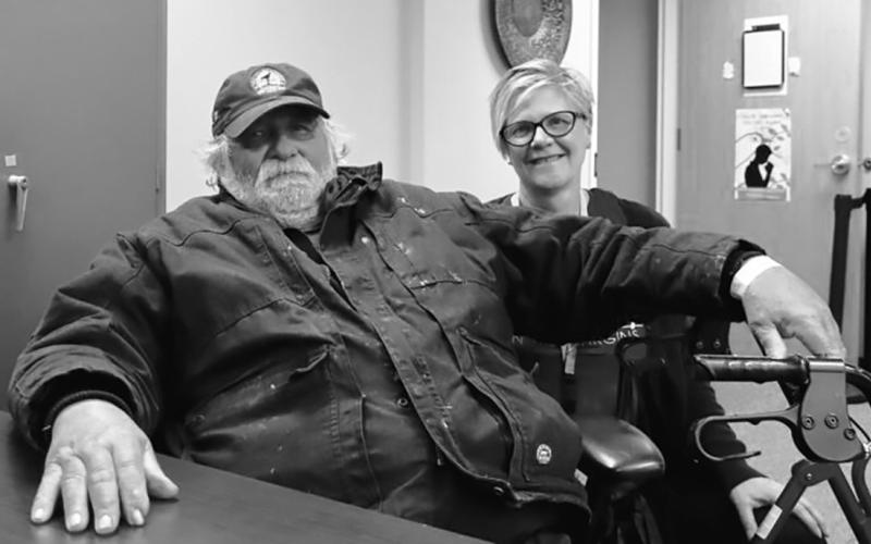 Michael Hauck, 64, left, a homeless veteran, sits next to Kris Morrissette, behavioral health manager at Ministry on the Margins in Bismarck, before being transported to a nearby hotel as he awaits approval to move into a nearby apartment on Nov. 6, 2025. (Photo by Michael Achterling/North Dakota Monitor)