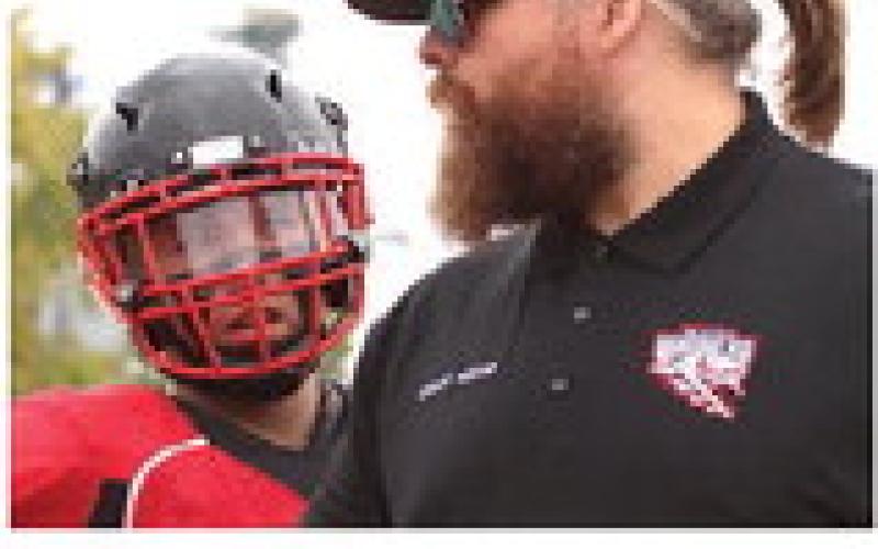 Coach Foster makes a point on the sidelines during Saturday's game. Not only was Saturday the coach's birthday - his wife gave birth to their first child on Friday.