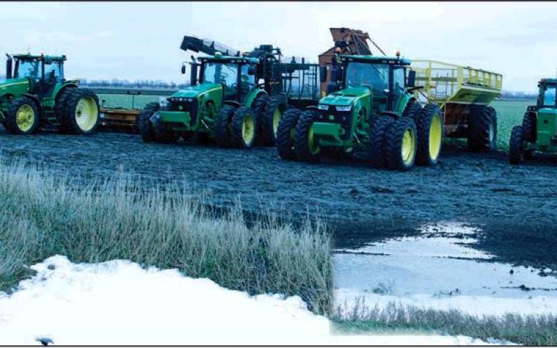 In a field NorthWest of Drayton equipment was waiting in a muddy field just waiting to start rolling again. Insert picture gives a clearer view of how many fields look with a mix of standing water, mud, and snow. VNV Photos by Lesa Van Camp
