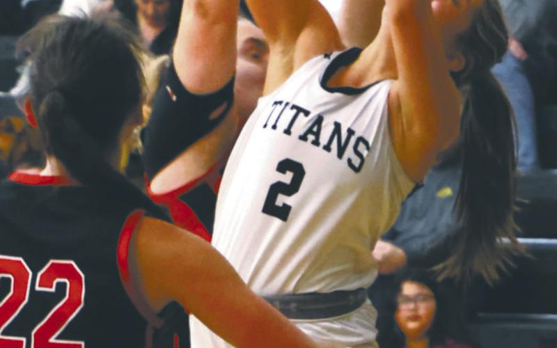 Brooke Gullickson shoots through a crowd against the Mustangs. Photo by Lyle Van Camp