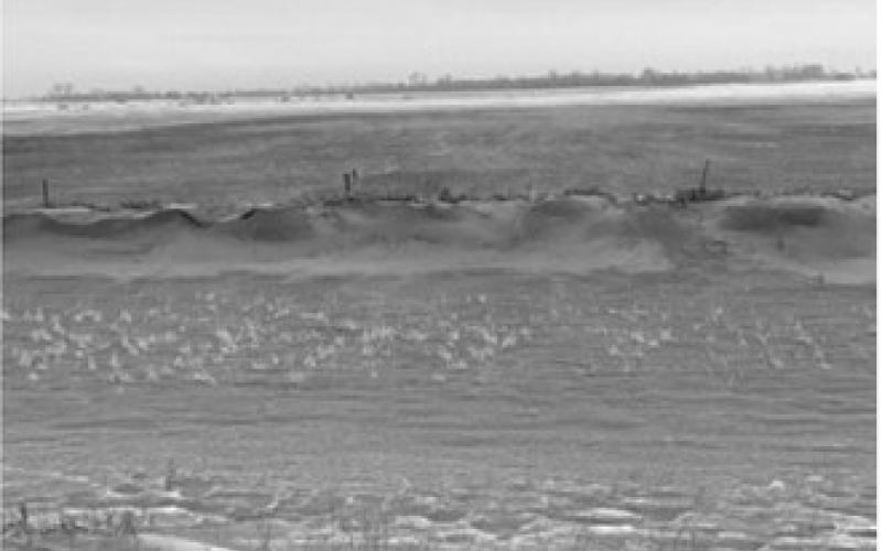 A roadside ditch along Highway 2, about 5 miles west of Grand Forks, North Dakota, full of topsoil from the adjoining field that was tilled in fall on Dec. 19, 2021.