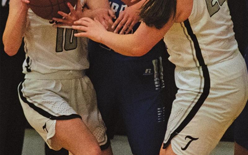 Easton Larson and Madison Hermanson battle under the basket with a couple Burros players. VNV Photo by Lesa Van Camp