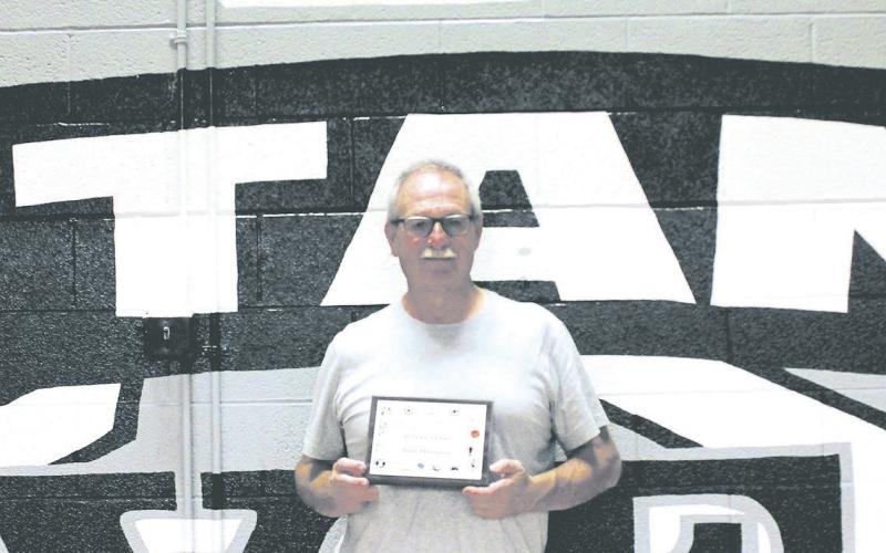 Drayton Coach Murph Thompson was recognized at Friday's volleyball game and presented with a plaque for 45 years of coaching service by the North Dakota High School Coaches Association. Photo by Jamie Rarick.