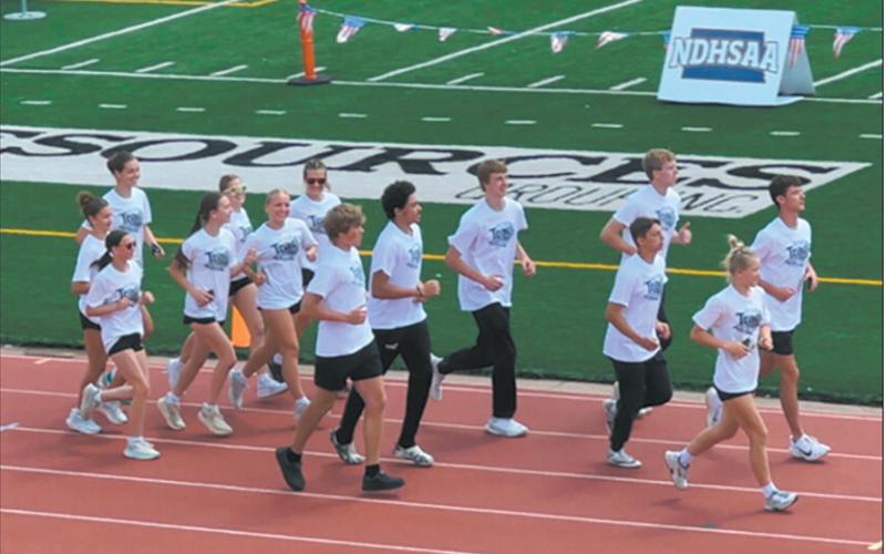 DVE Titans Parade of Athletes 2025 State Track and Field Meet from infield to track lanes, left to right: Elizabeth Fedje, Rosalyn Fedje, Milla Fagerholt; Greta Burrell, Jocelyn Vold; Violet Hoyles, Reese Fering; Jack Langerud, Mason Pollestad, Sam Kittelson; Carter Oberg, Carter Johnson; Brady Reilly, Alyssa Hoyles. Submitted photo