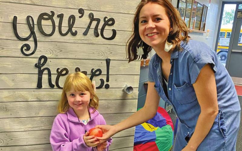 Suttyn Halvorson brings Mrs. Schumacher an apple for the first day of school. Photo submitted