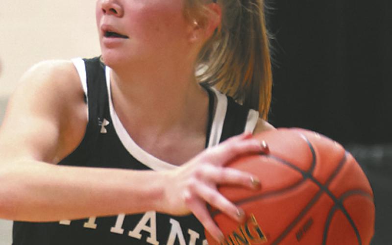 Easton Larson looks for an open teammate in the closing minutes of the Titans' win at Cavalier.