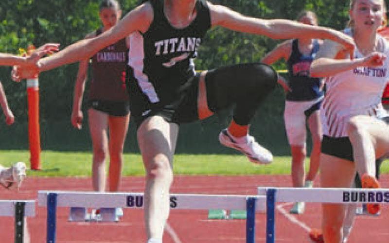 Elizabeth Fedje hurdling herself to first place. Photo by Larry Stokke.