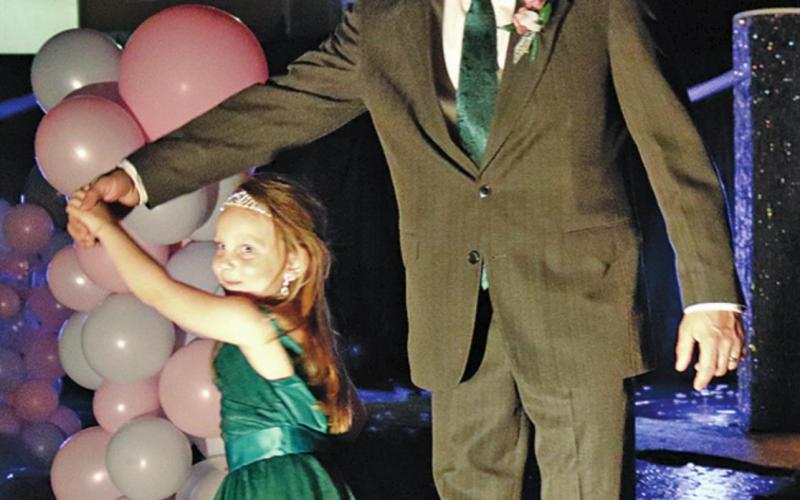 Brooks Stellon give daughter Amelia a twirl during the Grand March for the Daddy Daughter Dance. VNV Photo by Lesa Van Camp