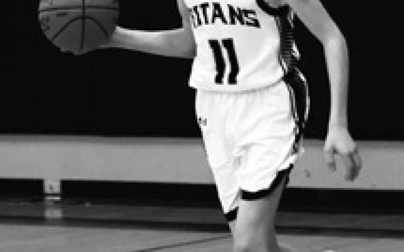 Quinn Passa brings the ball up the court in the closing moments of the game against North Border. Photo by Lyle Van Camp.