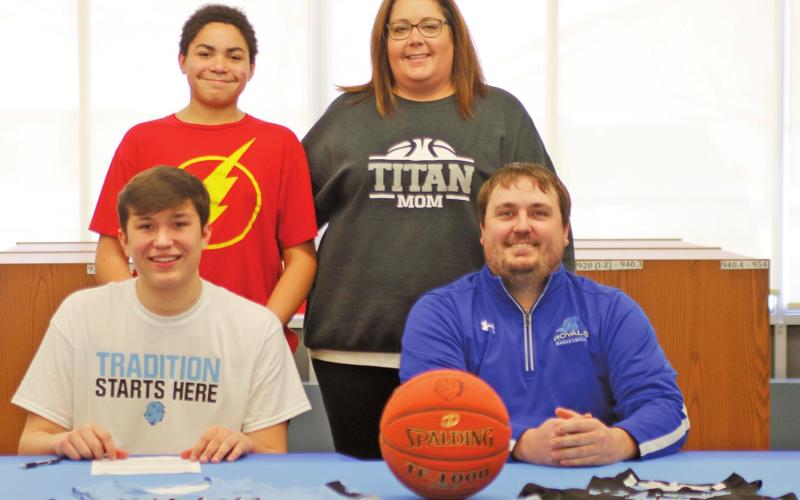 Gage Pollestad poses with his family and Coach following signing his intent to play basketball for Lake Region State College. Pictured front row I to r: Gage Pollestad and Royals Coach Jared Marshell, back row: Mason and Lindsay Pollestad. VNV Photo by Lesa Van Camp