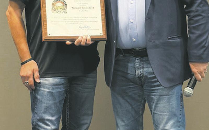 Scott Johnson, owner, (left) receives 2025 North Dakota Outstanding Pesticide Dealer of the Year at the North Dakota Ag Association meeting in Fargo, N.D. Pictured with North Dakota Ag Commissioner, Doug Goehring (right). Submitted photo.